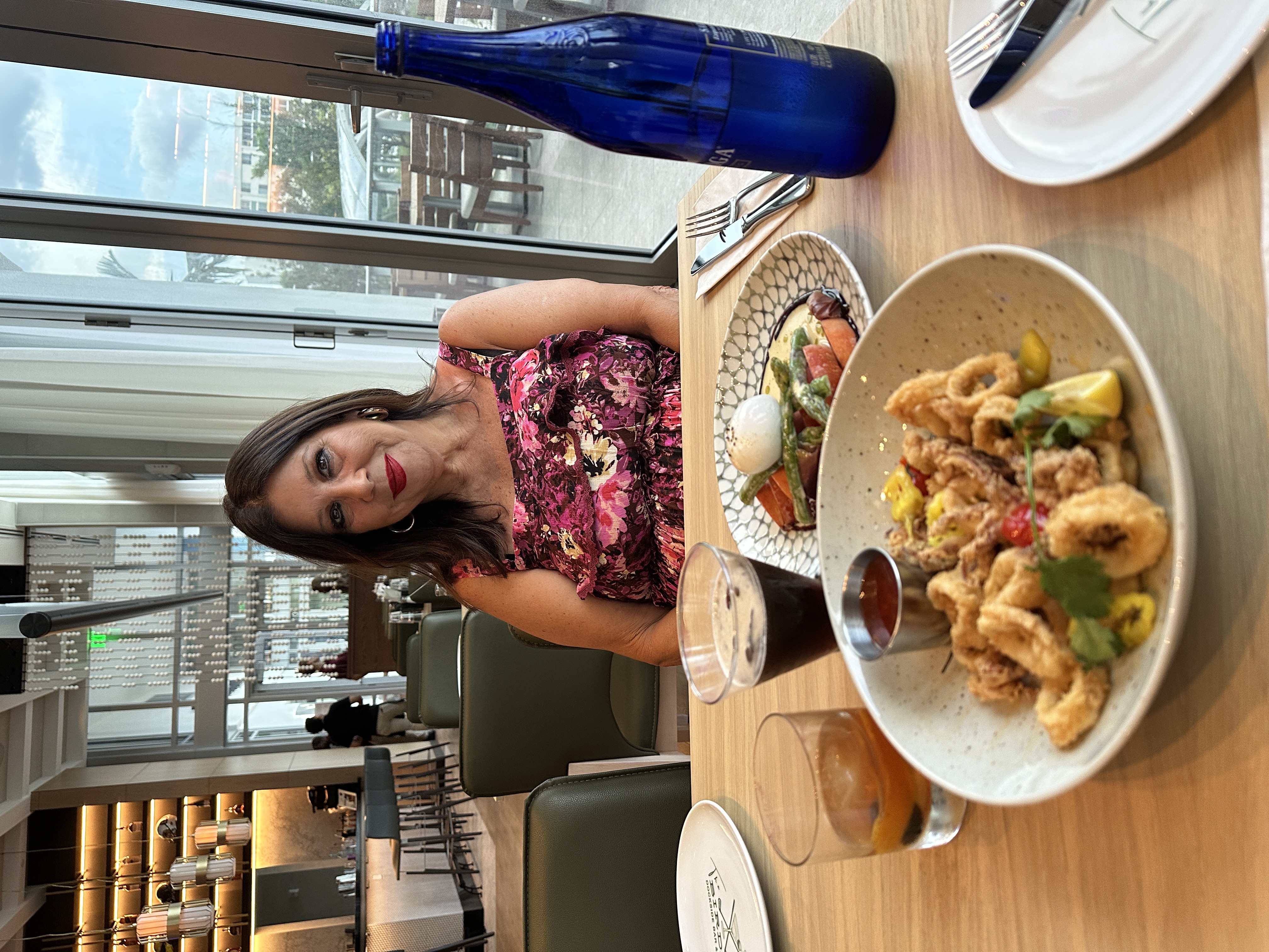 Maritza Cosano enjoying her Espresso Martini and The Hipster Crispy Calamari, a cripsy shishito peppers, radish, candied lemon, herbs, peppadew, sweet chili.